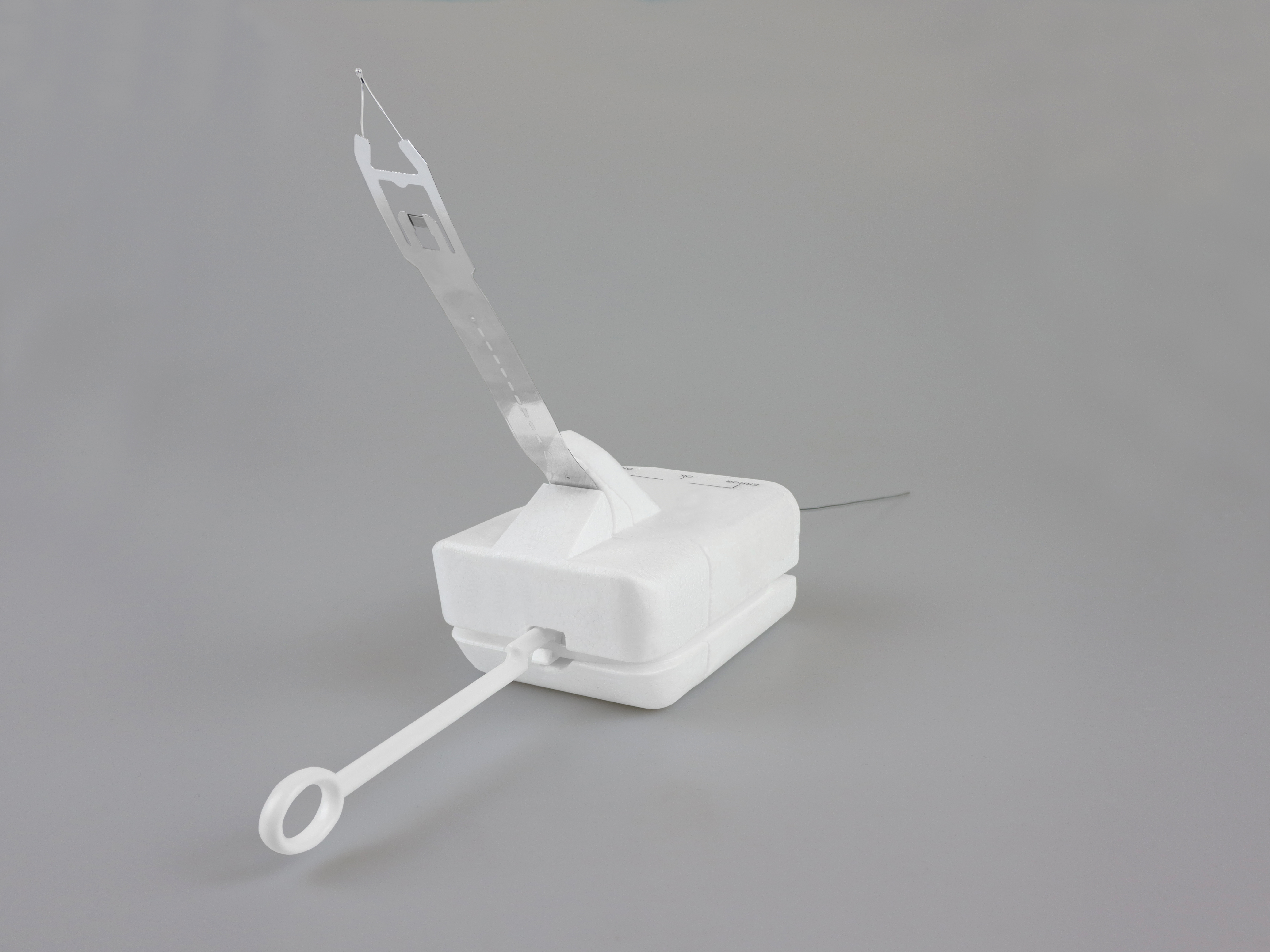 The image shows a white Graw DFM-17 radiosonde laying on a grey background