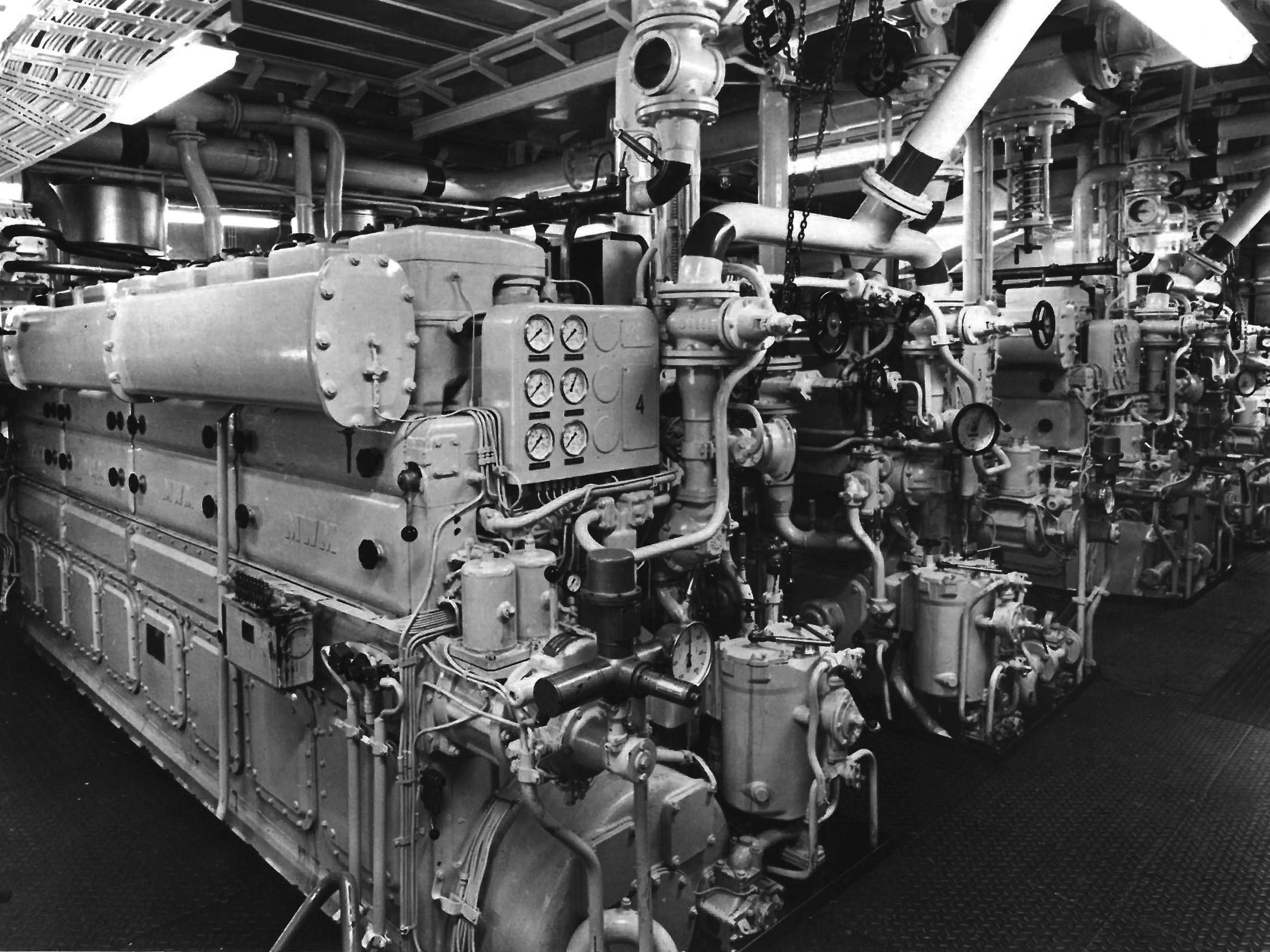 The image shows an old ships' engine room with MWM engines