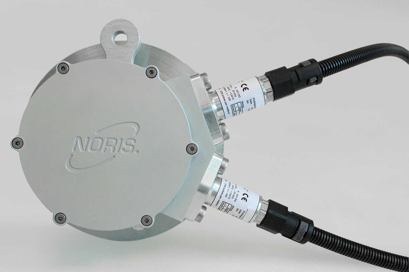 The images shows an axle pulse generator type NA56with two integrated speed sensors on a grey background.