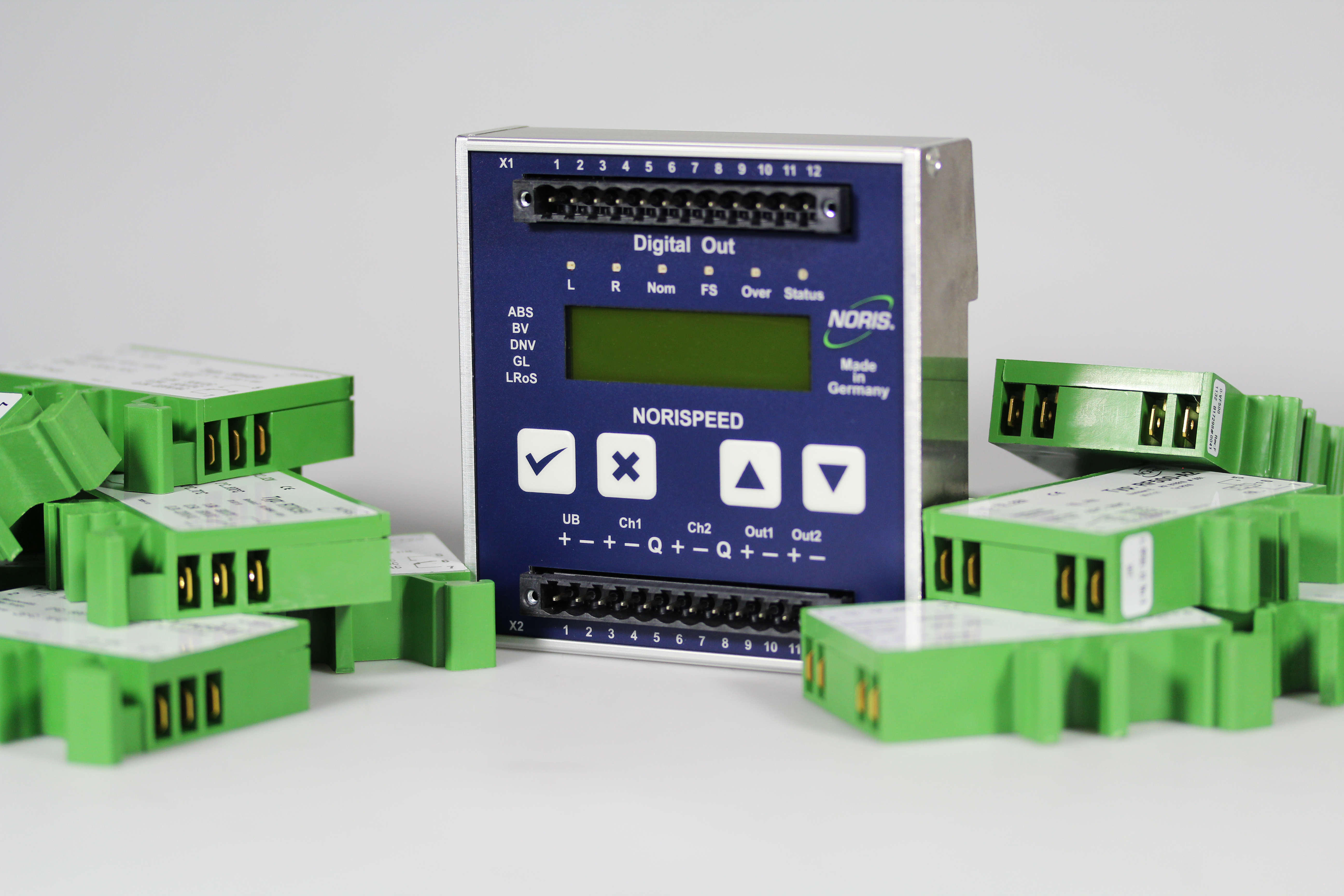 The image shows different green and blue signal processing devices laying on a grey background.